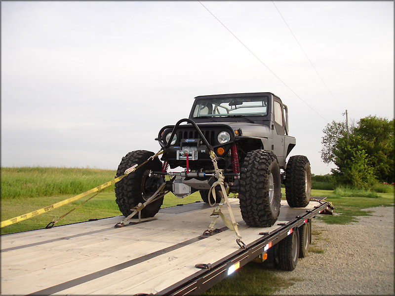 Using a J-hook on the axle to secure a Jeep to a trailer